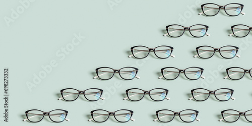 Glasses for vision on a green background with copy space. Optical store, vision test, stylish glasses concept. Banner