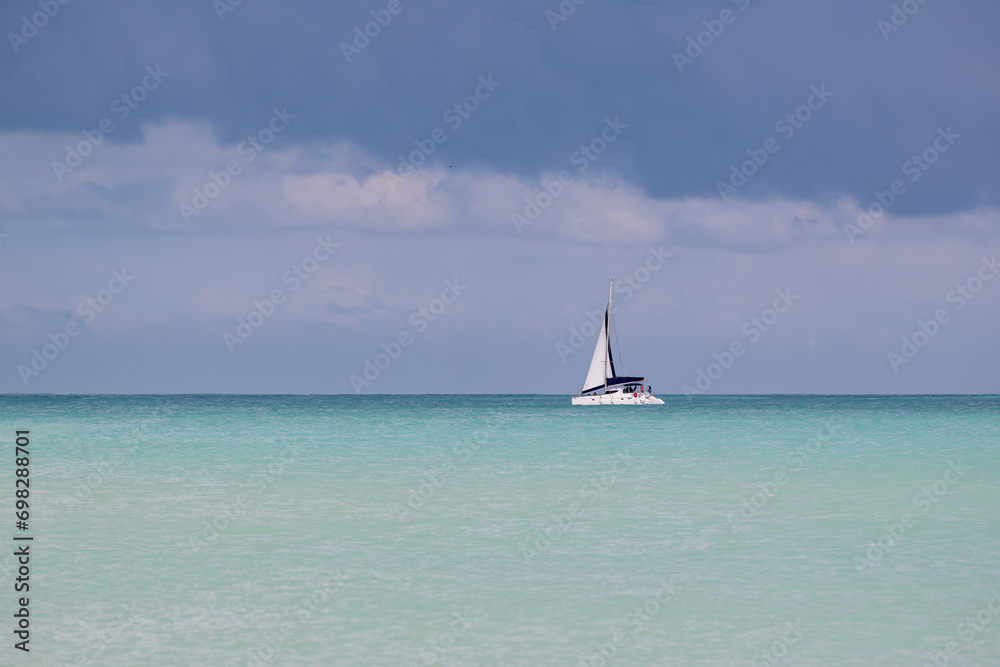 Caribbean turquoise waters and a sailing catamaran