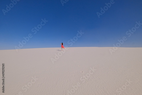 Fototapeta Naklejka Na Ścianę i Meble -  person walking on sand dune