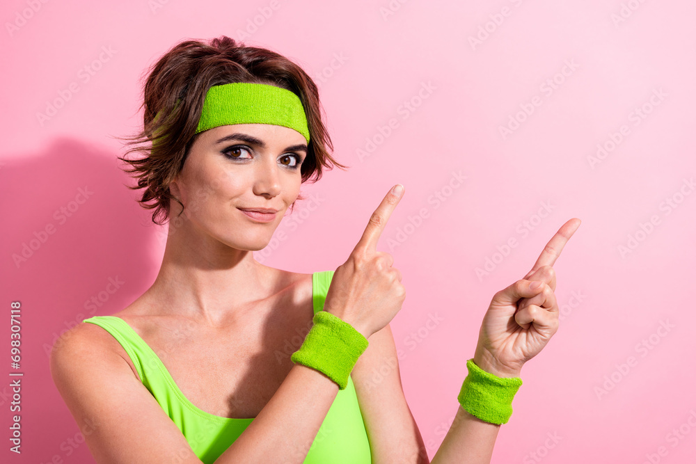 Photo of pretty shiny lady dressed green bodysuit showing two fingers empty space isolated pink color background Photo of pretty shiny lady dressed green bodysuit showing two fingers empty space isolated pink color background