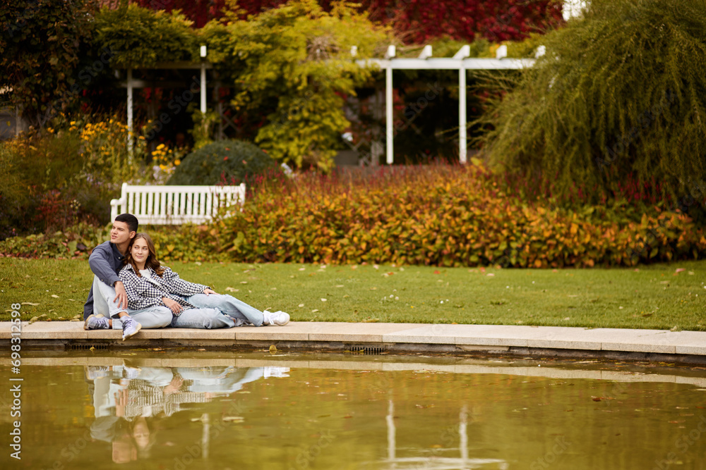 Young couple kissing and rejoices at the lake. lovely young couple kissing outdoors in autumn. Loving couple walking in nature. Autumn mood. Happy man and woman hugging and kissing in autumn. Love Young couple kissing and rejoices at the lake. lovely young couple kissing outdoors in autumn. Loving couple walking in nature. Autumn mood. Happy man and woman hugging and kissing in autumn. Love