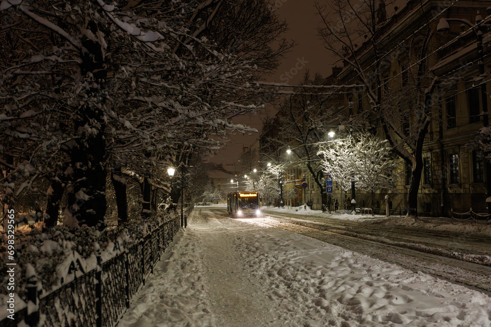 The bus travels along the evening winter road in Krakow.
