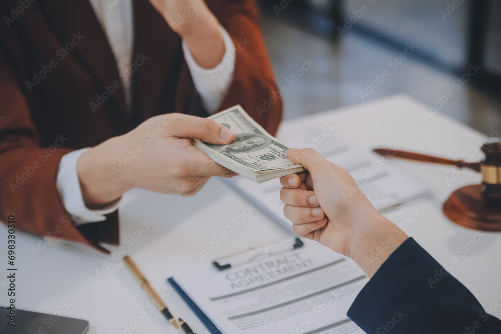 Fototapeta premium Lawyer, legal advisor, businessman brainstorming information on agreement details Business contracts in legal processing books for accuracy in contract documents. joint financial investment.