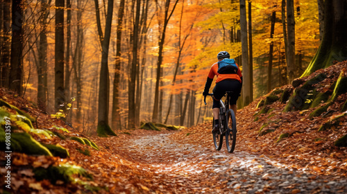A cyclist riding through a vibrant autumn forest surrounded by colorful foliage.