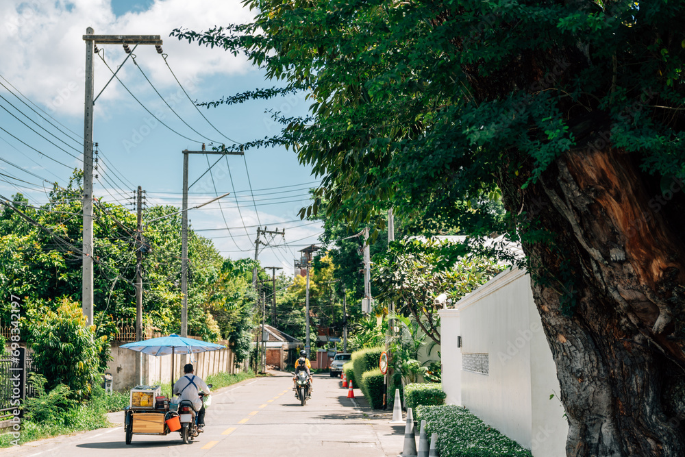 Street food cart bike and green tree road in Chiang Mai, Thailand