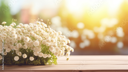 Baby's breath flowers basking in the golden sunlight on a rustic wooden table, a symbol of purity and innocence. photo