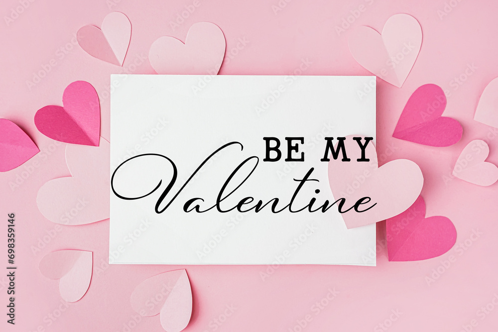 Beautiful greeting card for Valentine's Day with paper hearts on pink background