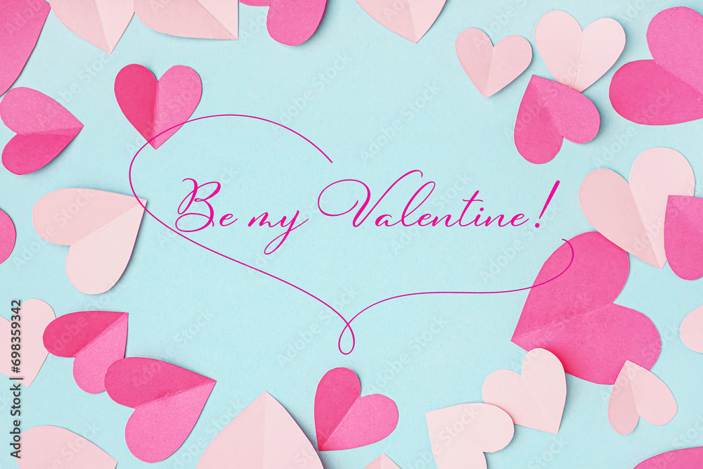 Beautiful greeting card for Valentine's Day with paper hearts on light blue background