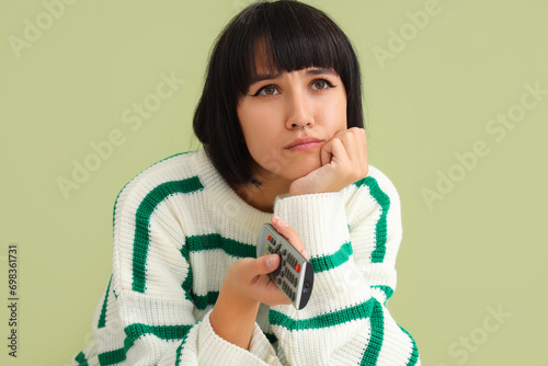 Young woman watching TV on ...