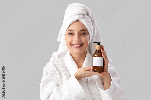 Mature woman in bathrobe wi...