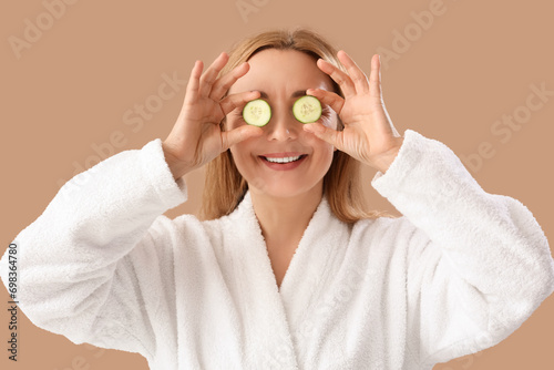 Mature woman in bathrobe wi...