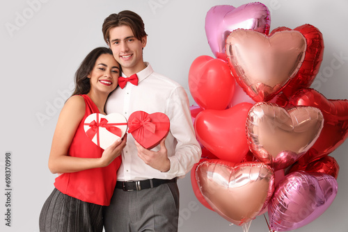 Young couple with gifts and...
