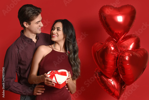 Young couple with gift box ...