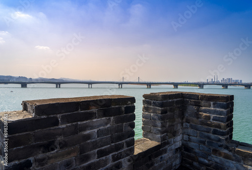 Standing on the ancient city wall, overlooking the city scenery of Xiangyang, Hubei Province, the intertwining of history and modernity is refreshing. photo