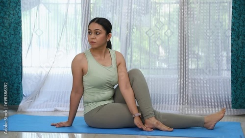Video Of Online Yoga Teacher Performing Vakrasana Yoga Pose.
 photo