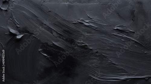 A close-up of an abstract black textured surface, creating an artistic and moody background. photo