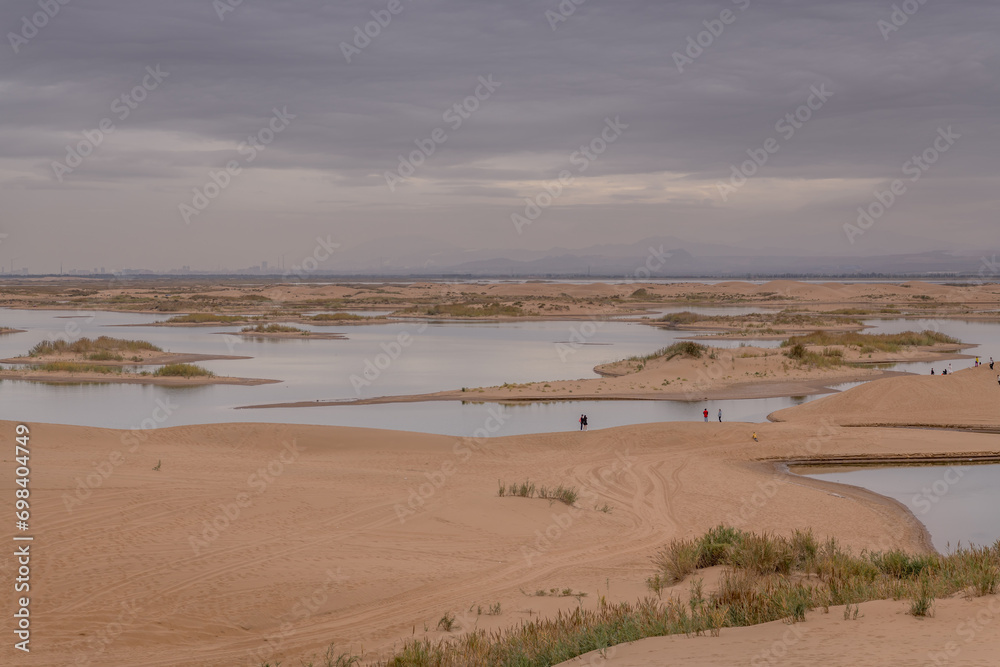 The river going through the desert in Wuhai, Inner Mongolia, China The river going through the desert in Wuhai, Inner Mongolia, China