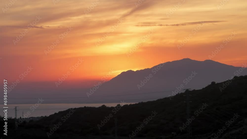 Sun setting behind the mountains near Marbella, Spain Sun setting behind the mountains near Marbella, Spain