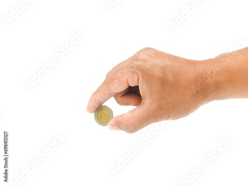 A man's hand holds a coin in his hand and is about to put the coin into something. Isolated on white background. business idea.