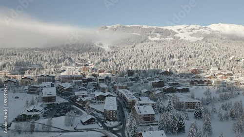 CRANS MONTANA the Alpine town in Switzerland in winter with lots of snow. Roofs with snow and frost photo