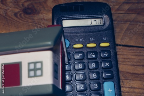 Calculator with the sign “Imu” Italian house tax. photo