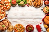 Selection of take out and fast foods. Corner border banner. Pizza, hamburgers, fried chicken and sides. Top down view on a white wood background with copy space 