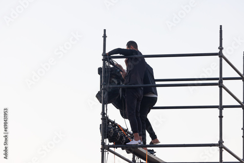 Sound technicians working on the installation of lights and spotlights