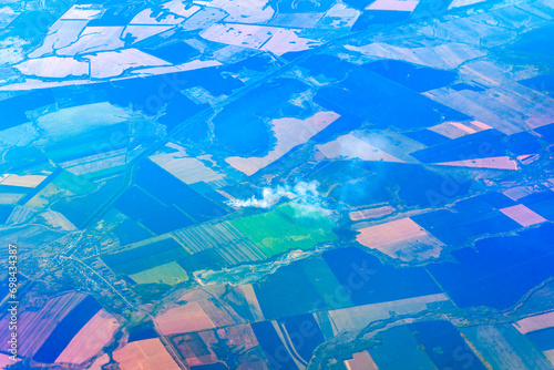 Forest and field fire, top view. Straw burns, emergency. Burning dry grass meadow due arid climate change hot weather and evironmental pollution. Aerial view.