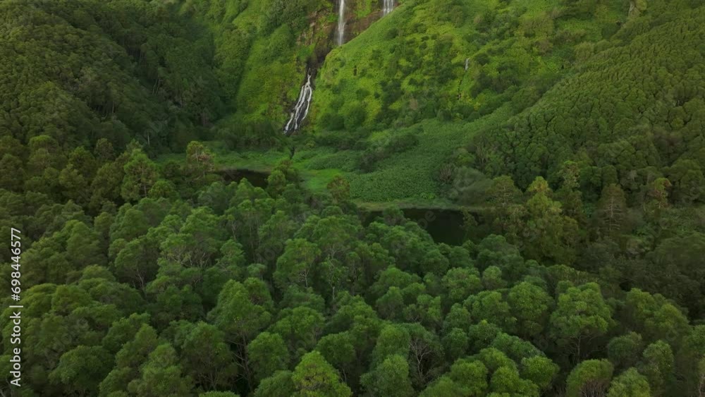 Wide view of waterfall Poço Ribeira do Ferreiro in Flores island - Drone shot