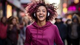 smiling afro girl with headphones on the street