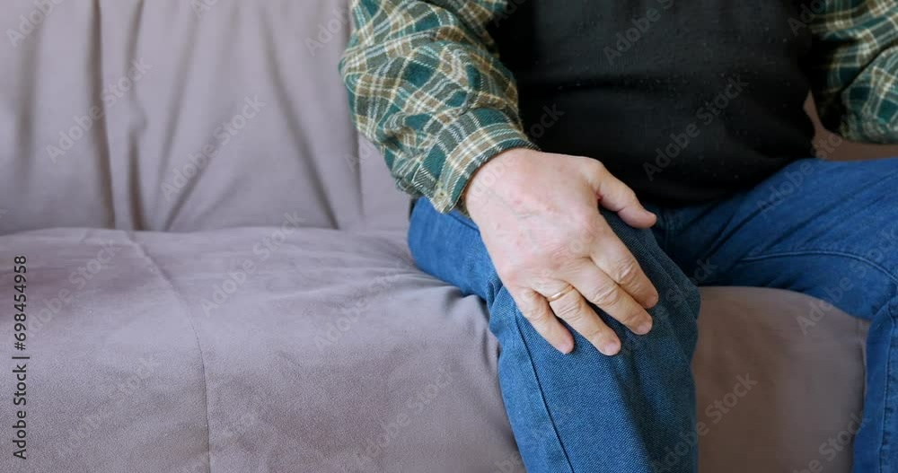 Senior man retirement knee joint pain on sofa. Senior man retirement knee joint pain on sofa.