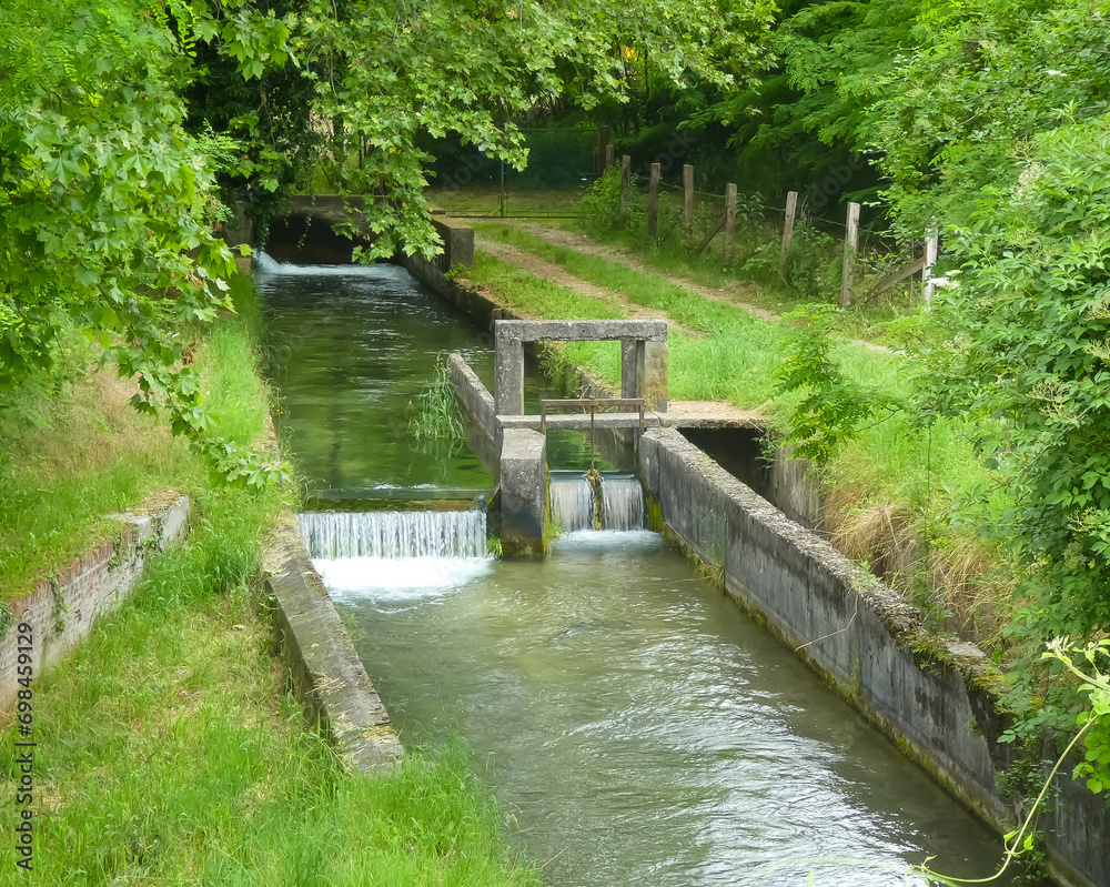 detail of small bulkhead to divert the watercourse of the ditch for the irrigation of cultivated fields during the summer season detail of small bulkhead to divert the watercourse of the ditch for the irrigation of cultivated fields during the summer season