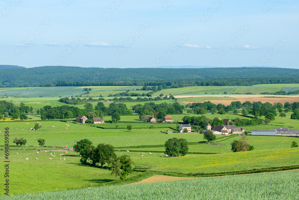 A French village in the green countryside in Europe, France, Burgundy, Nievre, Cuncy les Varzy, towards Clamecy, in Spring, on a sunny day.