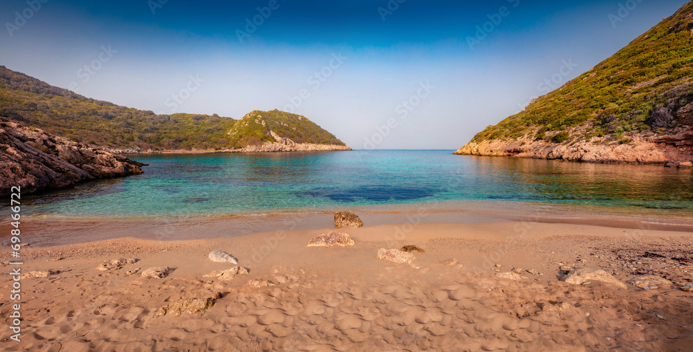 Sandy beach on Pirates Bay, Porto Timoni, Afionas village location. Amazing morning seascape of Ionian Sea. Colorful outdoor scene of Corfu island, Greece, Europe. Vacation concept background.