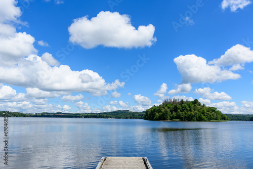 Lac des Settons amidst its green countryside in Europe, France, Burgundy, Nievre, towards Chateau Chinon, in summer on a sunny day. photo