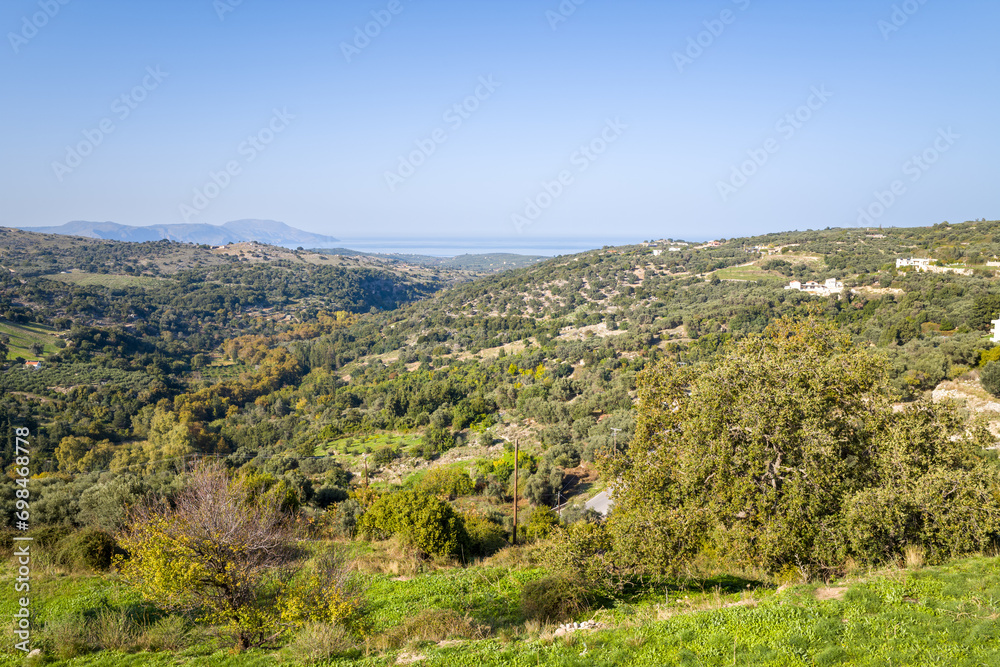 The green countryside among the mountains , Europe, Greece, Crete, Argiroupoli, towards Rethymnon, in summer, on a sunny day.