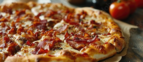 Bacon-topped pizza on a table.