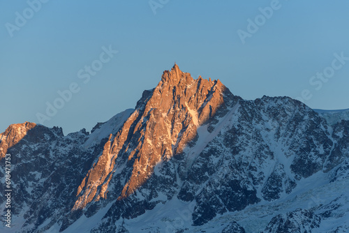 The Aiguille du Midi in the Mont Blanc massif at sunset in Europe, France, Rhone Alpes, Savoie, Alps, in winter on a sunny day. © Florent