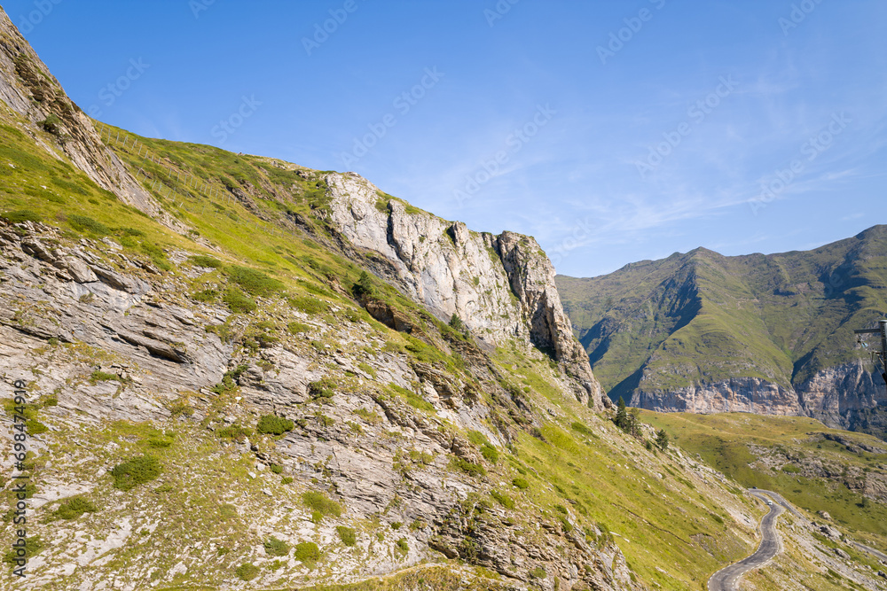 The Mountains around Gavarnie Gedre in the arid green countryside , Europe, France, Occitanie, Hautes-Pyrenees, in summer on a sunny day. The Mountains around Gavarnie Gedre in the arid green countryside , Europe, France, Occitanie, Hautes-Pyrenees, in summer on a sunny day.