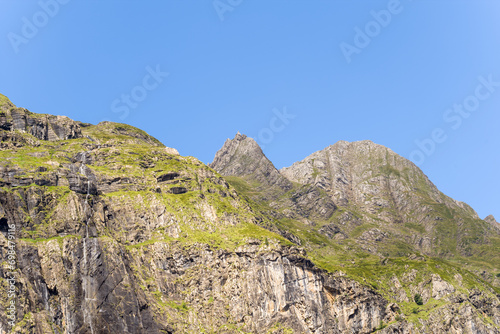 The barren rocky mountains in the middle of the countryside , Europe, France, Occitanie, Hautes-Pyrenees, in summer on a sunny day. © Florent