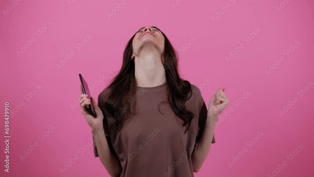 Joy of winning Emotions. Jackpot. Smiling shocked happy win beautiful young woman Look surprised wow hold using mobile cell phone. People. People lifestyle concept. Joy of winning Emotions. Jackpot. Smiling shocked happy win beautiful young woman Look surprised wow hold using mobile cell phone. People. People lifestyle concept.