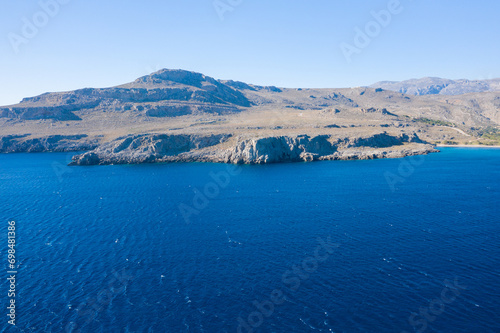 The barren rocky coast and mountains , in Europe, Greece, Crete, towards Sitia, By the Mediterranean sea, in summer, on a sunny day.