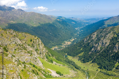 The Valley of Espone in the middle of the mountains and its green countryside , in Europe, in France, Occitanie, in the Hautes-Pyrenees, in summer, on a sunny day.