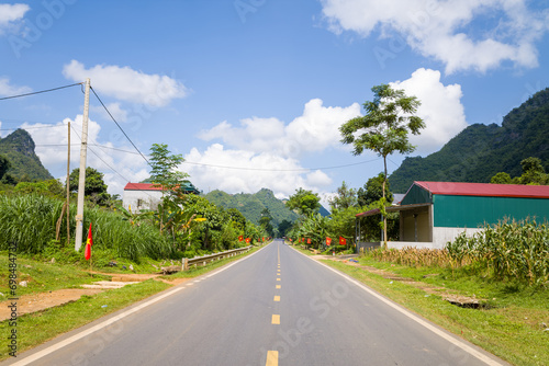 An asphalt road in the middle of the countryside and mountains  in Asia  Vietnam  Tonkin  between Son La and Dien Bien Phu  in summer  on a sunny day.