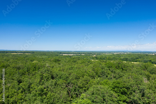 The green countryside with its forests and fields in Europe, France, Burgundy, Nievre, towards Nevers, in summer, on a sunny day. © Florent