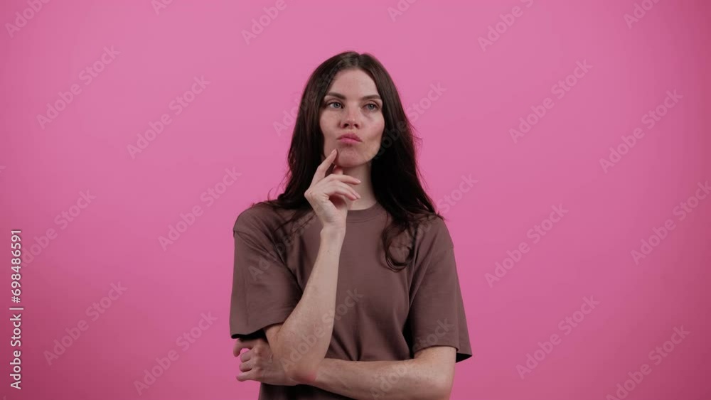 Young woman thinks deeply about something tries to make decision in mind. Pondering a solution, doubting question. Let me think. Emotions. People. Lifestyle concept Young woman thinks deeply about something tries to make decision in mind. Pondering a solution, doubting question. Let me think. Emotions. People. Lifestyle concept