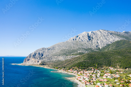 фотографія The town on the rocky coast in the middle of green countryside , Europe, Greece, Aetolia Acarnania, Kato Vasiliki towards Patras, by the Ionian Sea, in summer on a sunny day
