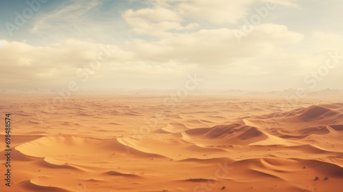  a desert landscape with sand dunes and a blue sky with a few clouds in the distance with a few clouds in the sky. photo