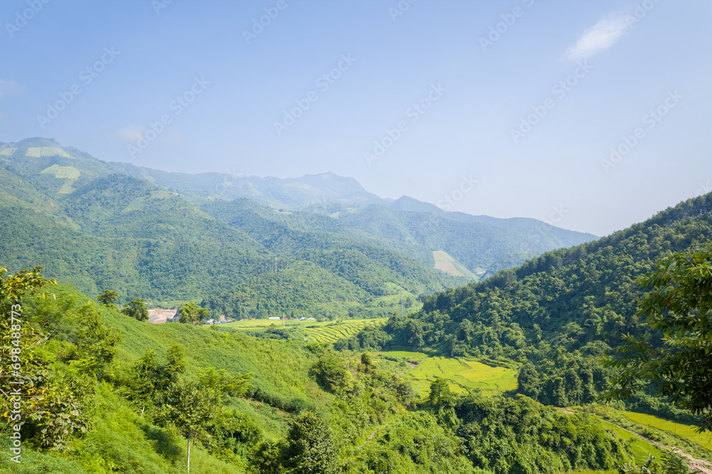 Rice fields in the middle of forests and green mountains, in Asia, Vietnam, Tonkin, between Dien Bien Phu and Lai Chau, in summer, on a sunny day. Rice fields in the middle of forests and green mountains, in Asia, Vietnam, Tonkin, between Dien Bien Phu and Lai Chau, in summer, on a sunny day.