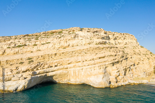 The caves in the rocky and limestone cliffs , in Europe, Greece, Crete, Matala, By the Mediterranean Sea, in summer, on a sunny day.